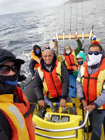 Our fishing charter boat on the water with guests enjoying a day of reef fishing in Cape Town
